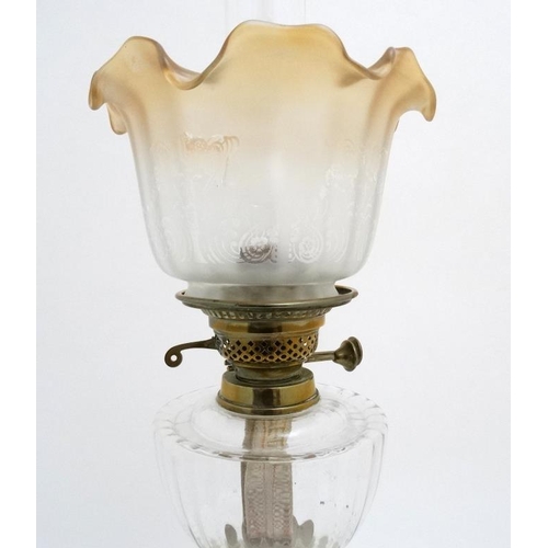 320 - Oil lamp : a c 1900 brass and glass oil lamp with circular reeded column, circular base , clear glas... 