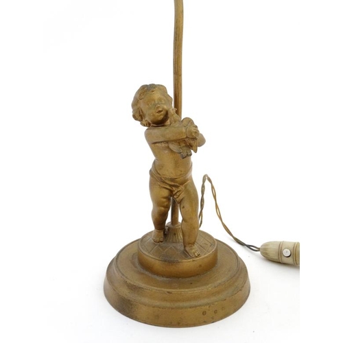 321 - An early 20 thC gilt spelter table lamp formed as a young figure with a bird on a circular socle 14 ... 