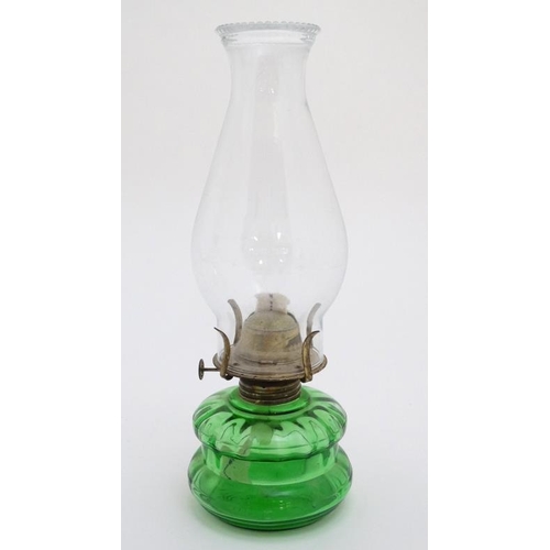 323 - Oil Lamps : two assorted glass lamps ,one green, both with chimneys