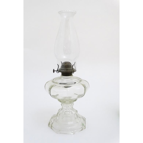 323 - Oil Lamps : two assorted glass lamps ,one green, both with chimneys