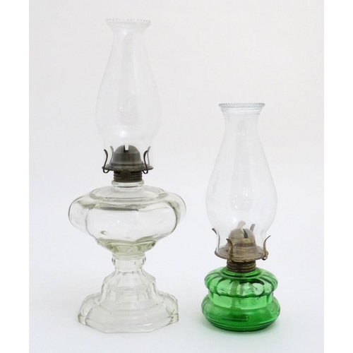 323 - Oil Lamps : two assorted glass lamps ,one green, both with chimneys