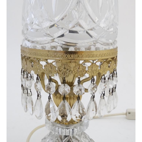 326 - Crystal lamp : an electric clear and frosted glass with ormolou table lamp surmounted by a small che... 