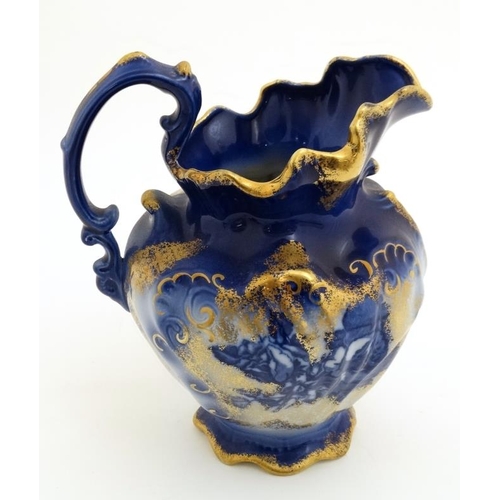 518 - A Victoria ware Ironstone flow blue (flo-blue) style large pitcher and bowl , decorated with flowers... 