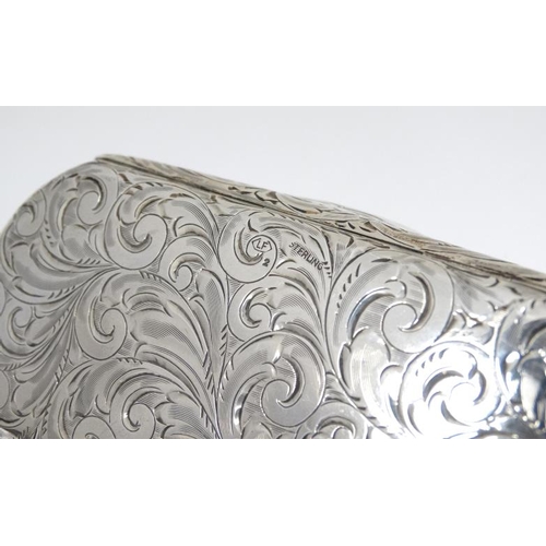 527 - A Sterling silver spectacle / glasses case with engraved acanthus scroll decoration. Marked Sterling... 