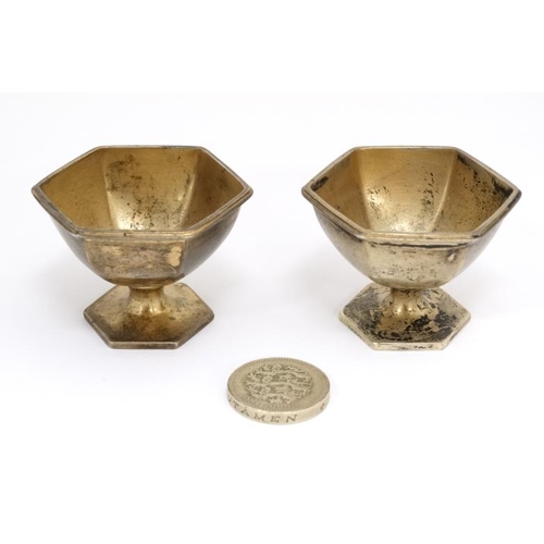 529 - A pair of silver gilt salts of hexagonal pedestal form. Marked Sterling 1 1/4'' high (46g)