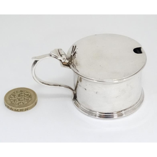 530 - A silver mustard pot with hinged lid and blue glass liner . Hallmarked Birmingham 1938 maker S Blanc... 