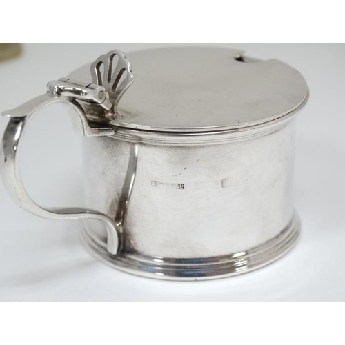 530 - A silver mustard pot with hinged lid and blue glass liner . Hallmarked Birmingham 1938 maker S Blanc... 