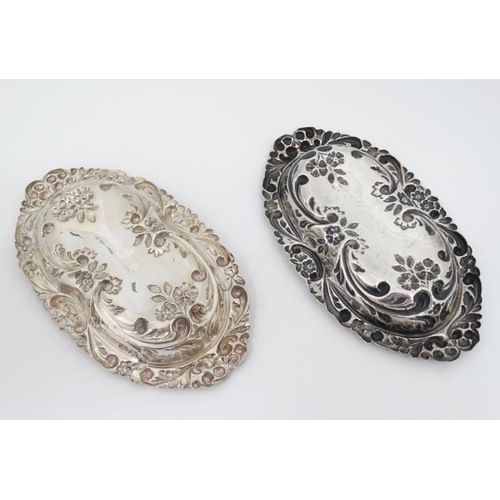 533 - A matched pair of silver dishes with embossed floral and scroll decoration. Hallmarked Birmingham 18... 