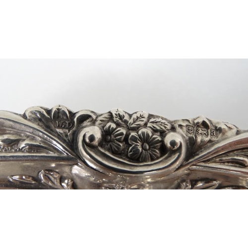 533 - A matched pair of silver dishes with embossed floral and scroll decoration. Hallmarked Birmingham 18... 