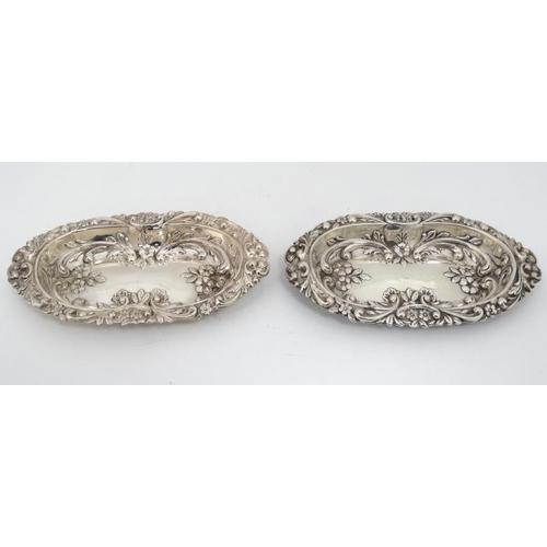 533 - A matched pair of silver dishes with embossed floral and scroll decoration. Hallmarked Birmingham 18... 