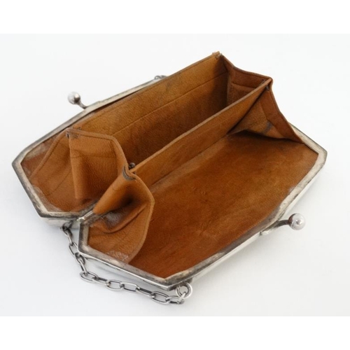 534 - A silver purse with engraved decoration and calf skin lined interior, hallmarked Birmingham 1917 mak... 