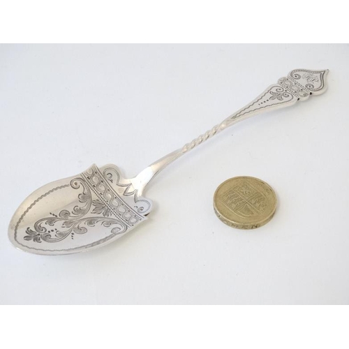 536 - A silver preserve spoon with shaped handle and spade formed bowl with engraved decoration 6'' long (... 