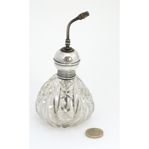 537 - A cut glass scent bottle with the silver mounts hallmarked Chester 1909 maker James Deakin & Sons.