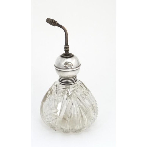 537 - A cut glass scent bottle with the silver mounts hallmarked Chester 1909 maker James Deakin & Sons.