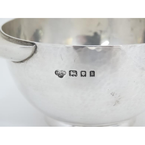 539 - A silver porringer with hammered decoration. Hallmarked London 1925 maker Goldsmiths & Silversmiths ... 