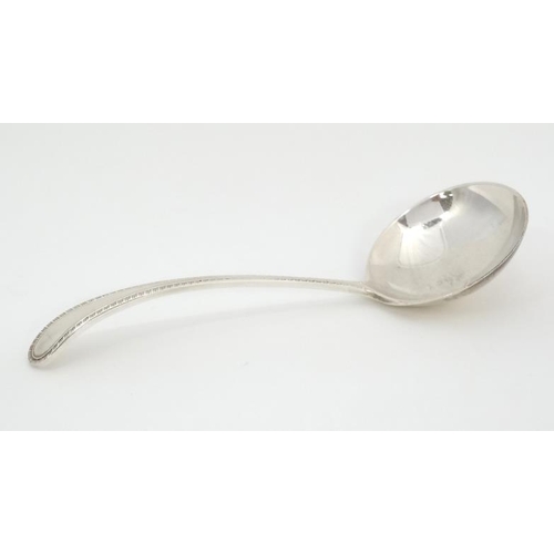 543 - A silver sauce ladle with feather edge handle hallmarked Birmingham 1966 maker  Joseph Gloster Ltd. ... 