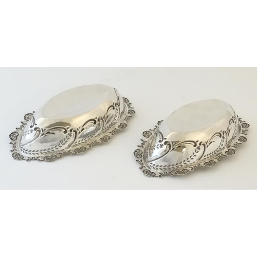 546 - A pair of silver dishes with embossed and pierced decoration. Hallmarked Chester 1903 maker W Coulth... 