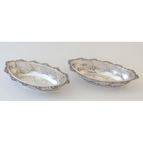 546 - A pair of silver dishes with embossed and pierced decoration. Hallmarked Chester 1903 maker W Coulth... 