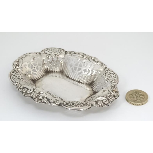 548 - A silver bon bon dish with pierced and embossed decoration. Hallmarked 1902 maker TM. 5'' wide (26g)