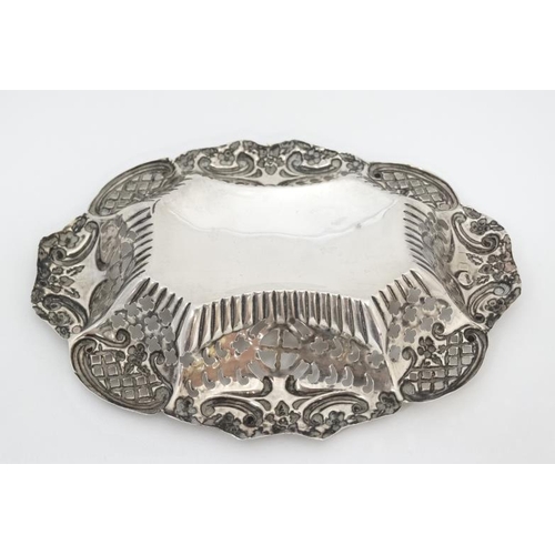 548 - A silver bon bon dish with pierced and embossed decoration. Hallmarked 1902 maker TM. 5'' wide (26g)