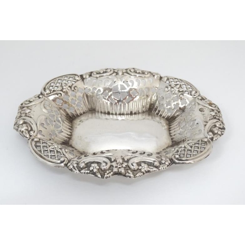 548 - A silver bon bon dish with pierced and embossed decoration. Hallmarked 1902 maker TM. 5'' wide (26g)