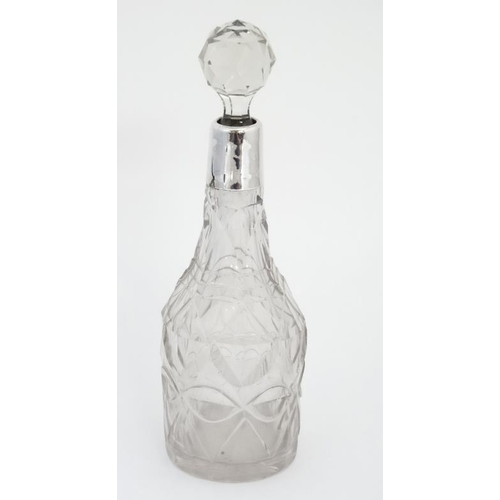 555 - A cut glass dressing table bottle with silver collar hallmarked Chester 1913 . The whole 7 1/2'' hig... 