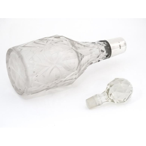 555 - A cut glass dressing table bottle with silver collar hallmarked Chester 1913 . The whole 7 1/2'' hig... 