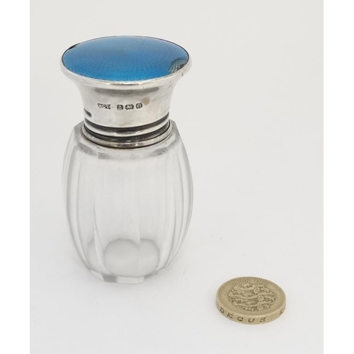 559 - A glass salts / scent bottle with silver top having turquoise guilloché enamel decoration. Hallmarke... 