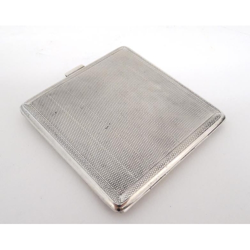 560 - A silver cigarette case with engine turned decoration. Hallmarked Birmingham 1927 maker Adie Bros Lt... 