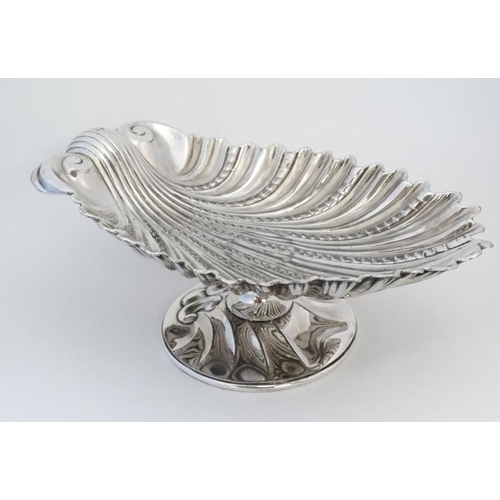 566 - A silver pate tazza / pedestal bowl formed as a scallop shell 11 3/4'' wide x 4'' high