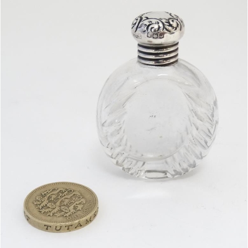 567 - A cut glass scent / salts bottle with silver top hallmarked Birmingham 1905 maker G E Walton & Co Lt... 