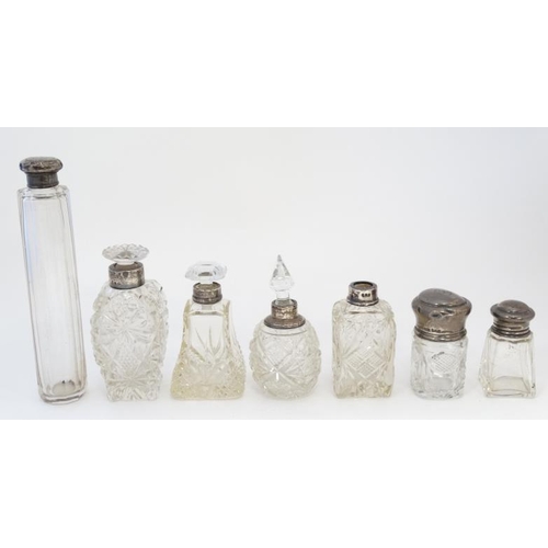 569 - 7 assorted glass and silver mounted dressing table bottles . The tallest 7'' long