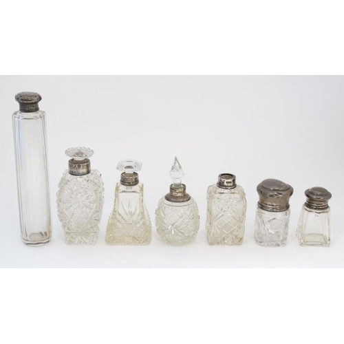 569 - 7 assorted glass and silver mounted dressing table bottles . The tallest 7'' long