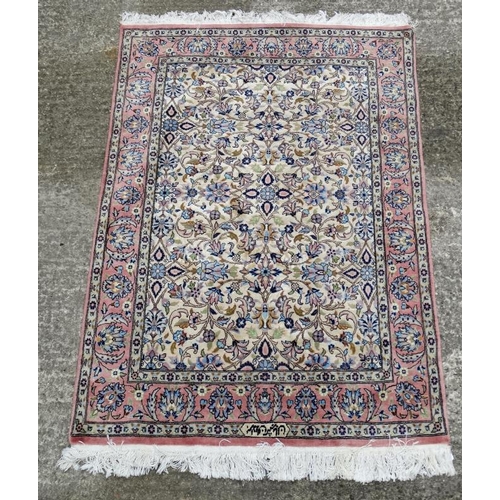 57 - Carpet / Rug: a Signed Pakistan made deepish pile (silk like ) woollen hand made rug , with salmon p... 