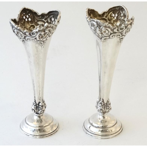 572 - A pair of silver bud vases embossed and pierced decoration. Hallmarked 1898 maker Henry Matthews 6''... 