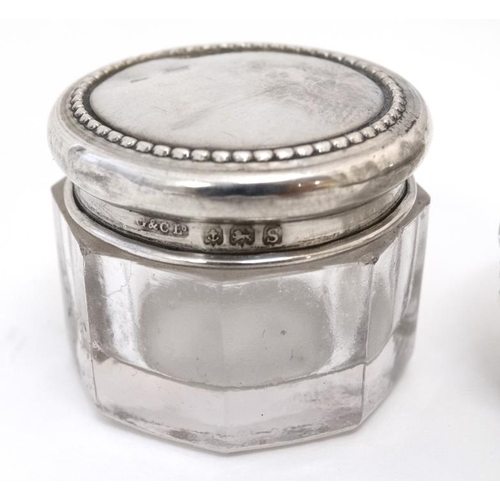 575 - 2 cut glass dressing table pots with silver lids. Hallmarked Birmingham 1917 maker G& C Ltd and Birm... 