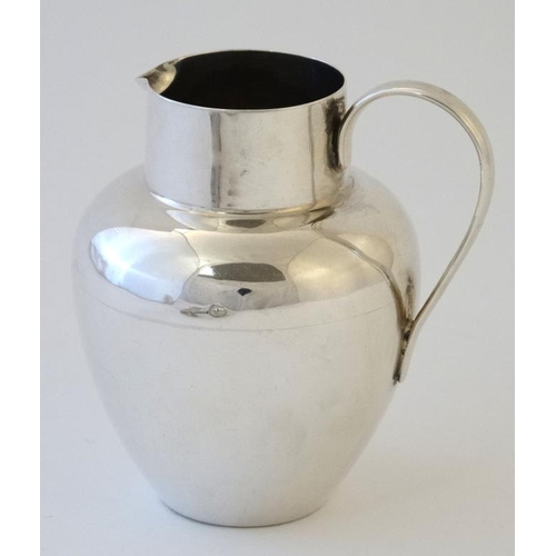 577 - A silver cream jug with loop handle hallmarked Birmingham 1903 maker William Henry Sparrow 3 1/4'' h... 