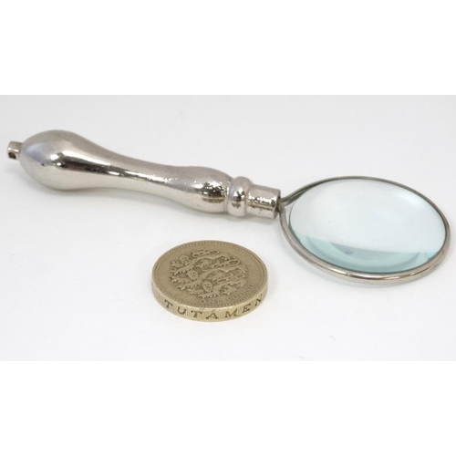 580 - A small magnifying glass with silver plate handle. 3 3/4'' long