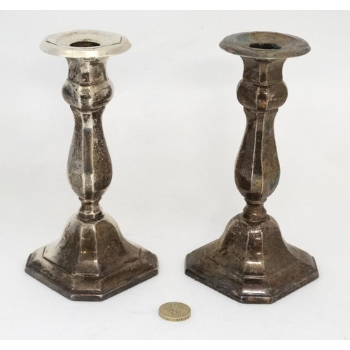 582 - A pair of silver plated candlesticks  7'' high