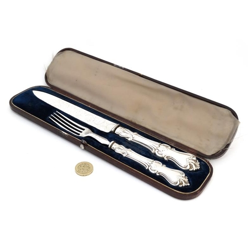 587 - A Victorian silver and close plate carving set comprising knife and fork within a  Moroccan leather ... 