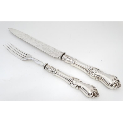 587 - A Victorian silver and close plate carving set comprising knife and fork within a  Moroccan leather ... 