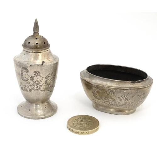 593 - A white metal pepperette and salt in the Chinese Export style with engraved dragon decoration Indist... 