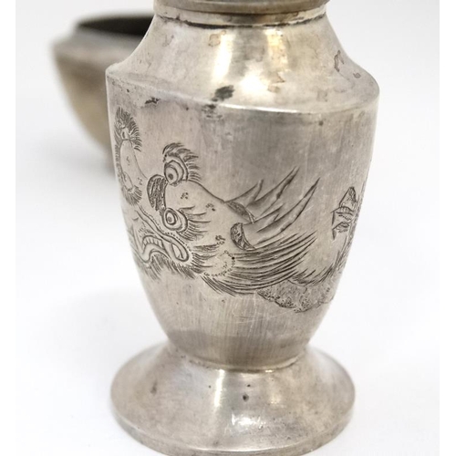 593 - A white metal pepperette and salt in the Chinese Export style with engraved dragon decoration Indist... 