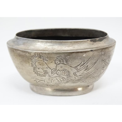 593 - A white metal pepperette and salt in the Chinese Export style with engraved dragon decoration Indist... 