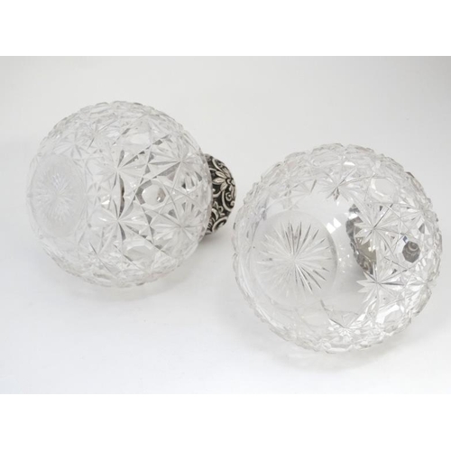 597 - A pair of cut glass scent bottle of spherical form with silver tops hallmarked Chester 1904 maker Wi... 