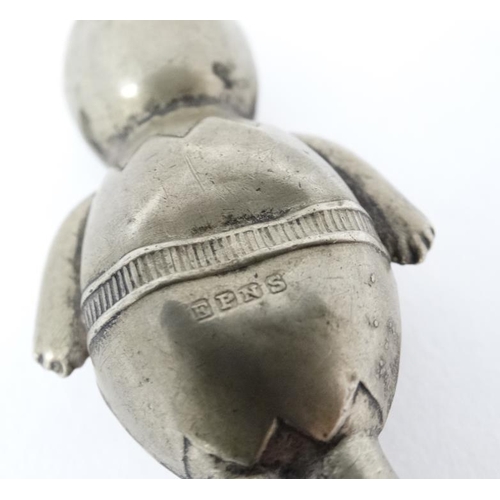 598 - A silver plate rattle formed as a stylized Kewpie doll with ivorine teether ring.