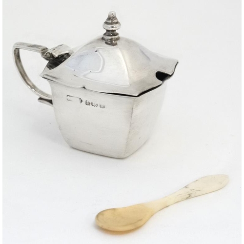 603 - A silver mustard pot of squared form hallmarked Birmingham 1933 together with a bone spoon