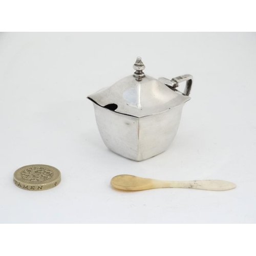 603 - A silver mustard pot of squared form hallmarked Birmingham 1933 together with a bone spoon