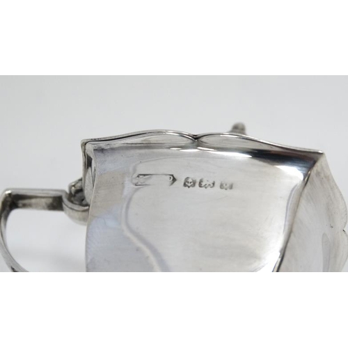 603 - A silver mustard pot of squared form hallmarked Birmingham 1933 together with a bone spoon