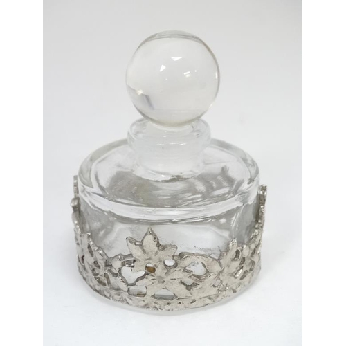 604 - A glass scent bottle with applied white metal decoration. Approx 2 1/2'' high